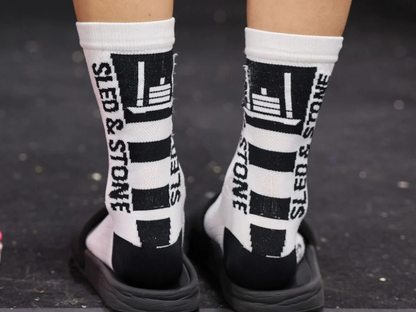 The Updraft race sock in white with black, Sled & Stone knitted down the cuff — view 4