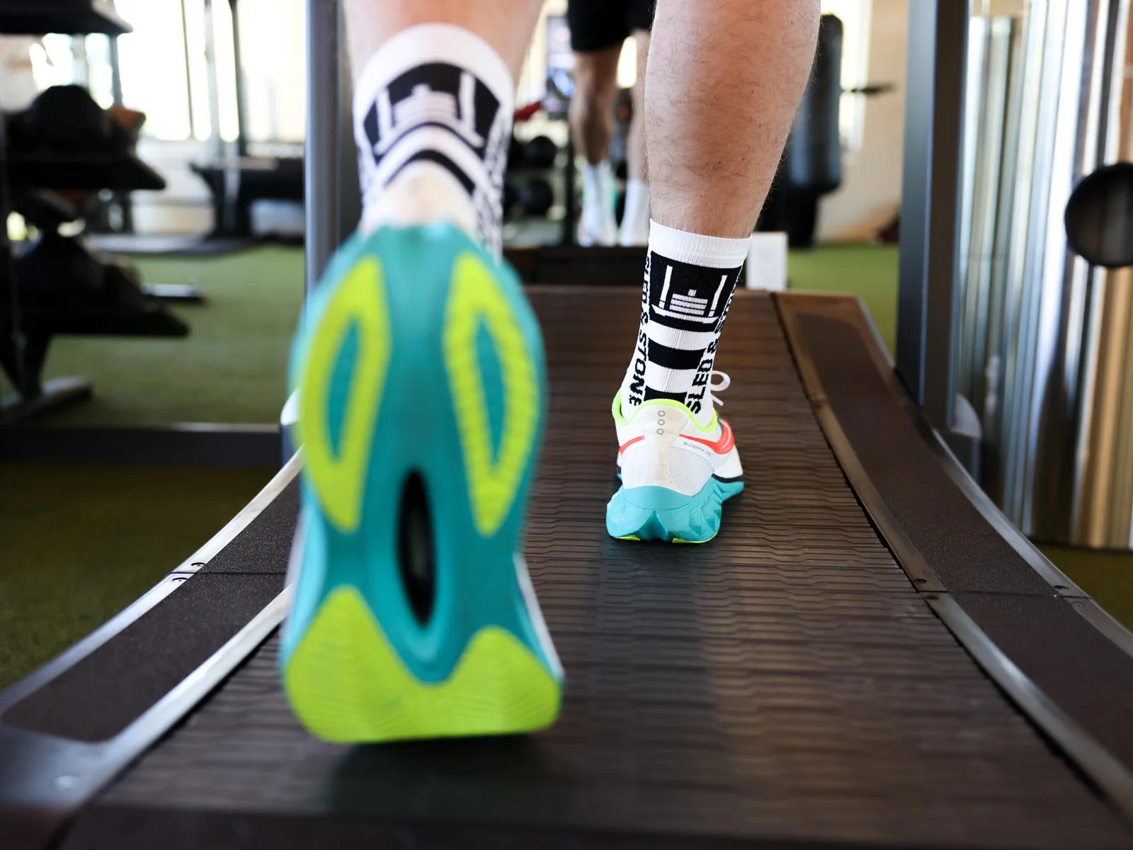 The Updraft race sock in white with black, Sled & Stone knitted down the cuff — view 2